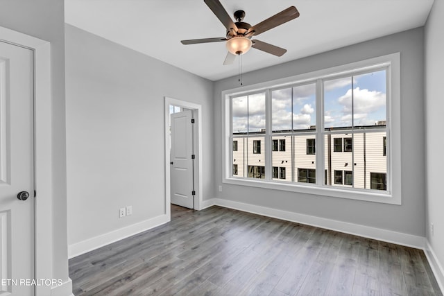 empty room with ceiling fan and hardwood / wood-style floors