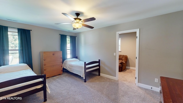 bedroom featuring ceiling fan and light colored carpet