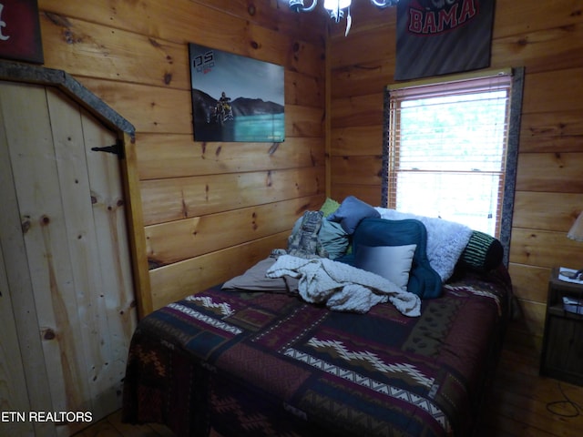 bedroom featuring wood walls