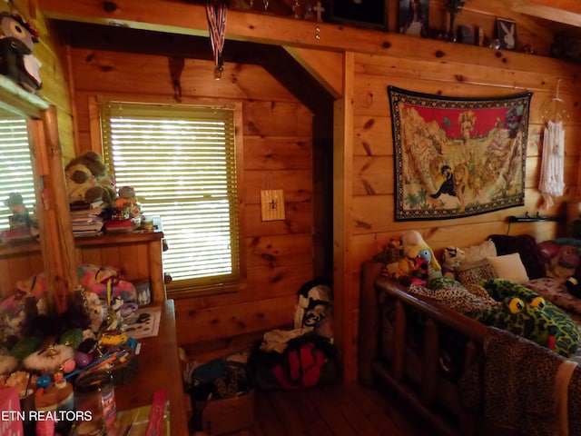 bedroom featuring wood walls