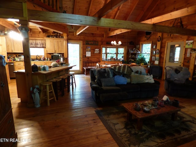 living room with wood ceiling, wooden walls, hardwood / wood-style floors, and vaulted ceiling with beams