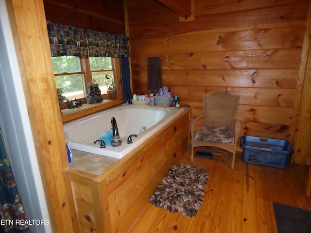 bathroom featuring wood-type flooring and a washtub