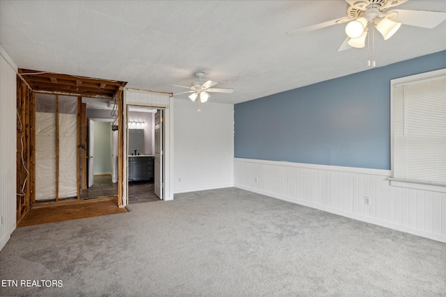 carpeted empty room with ceiling fan