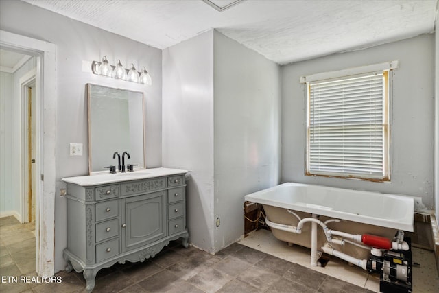 bathroom with vanity and a tub to relax in