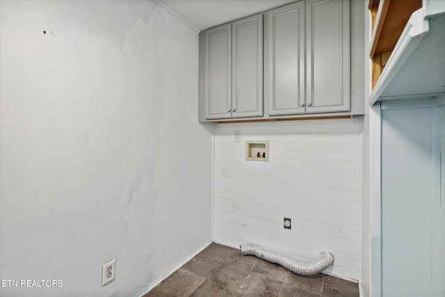 laundry room featuring hookup for a washing machine and cabinets