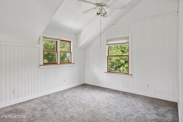 additional living space featuring carpet, lofted ceiling, and ceiling fan