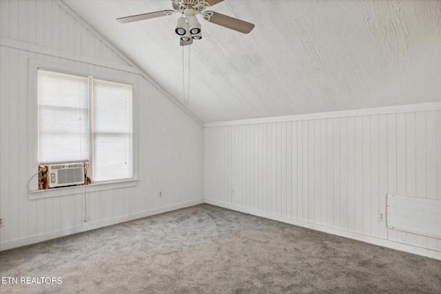 bonus room with cooling unit, ceiling fan, lofted ceiling, and carpet flooring