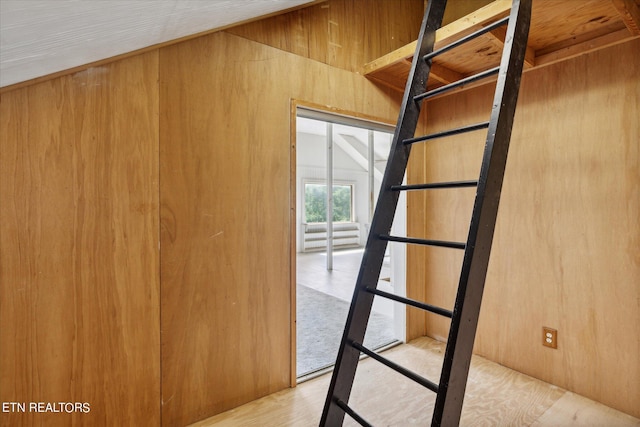 interior space with wood-type flooring and wood walls