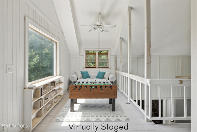 interior space featuring vaulted ceiling, plenty of natural light, and ceiling fan