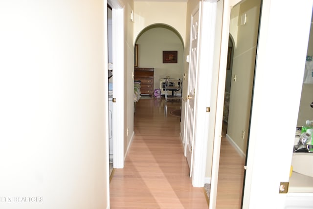 corridor with light hardwood / wood-style flooring