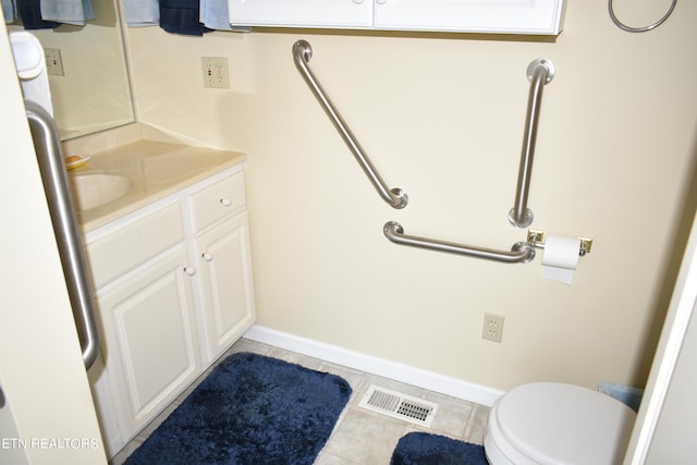 bathroom featuring vanity, tile patterned flooring, and toilet