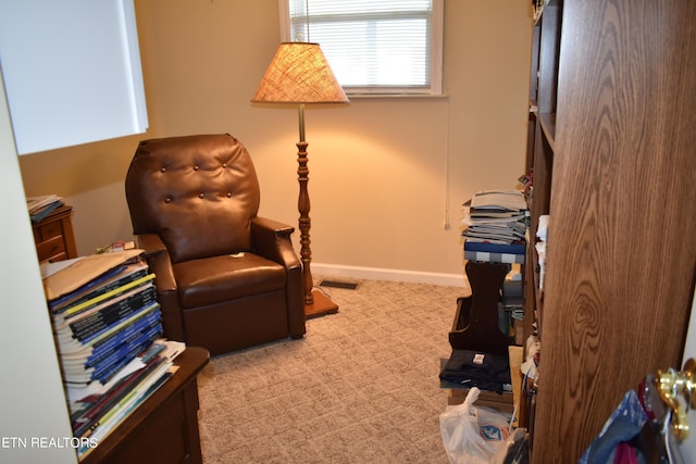 sitting room featuring light carpet