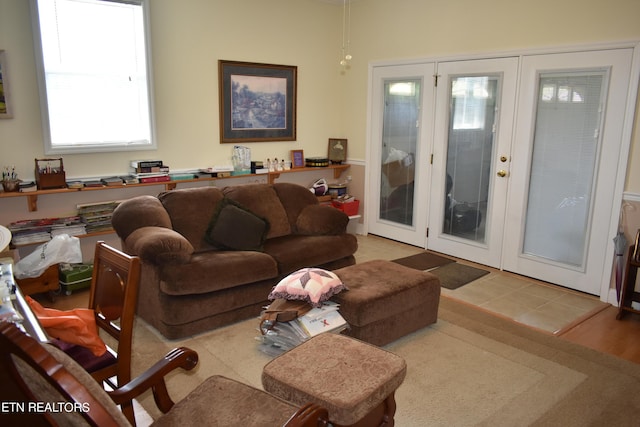 living room featuring light hardwood / wood-style floors, french doors, and plenty of natural light