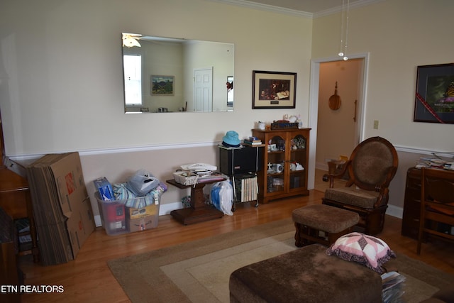 living room featuring ornamental molding, ceiling fan, and hardwood / wood-style floors