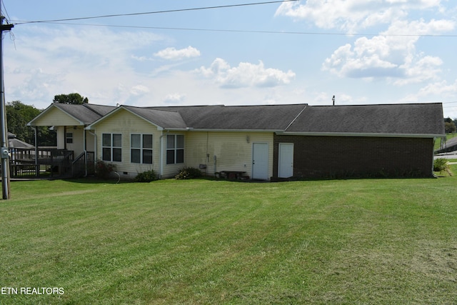 rear view of property featuring a yard