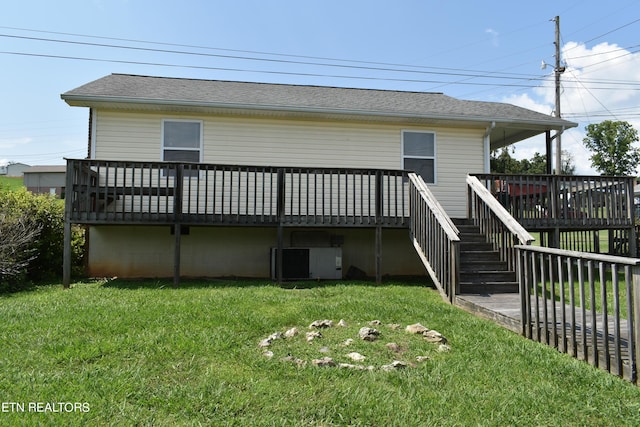 back of house featuring a yard, a wooden deck, and cooling unit