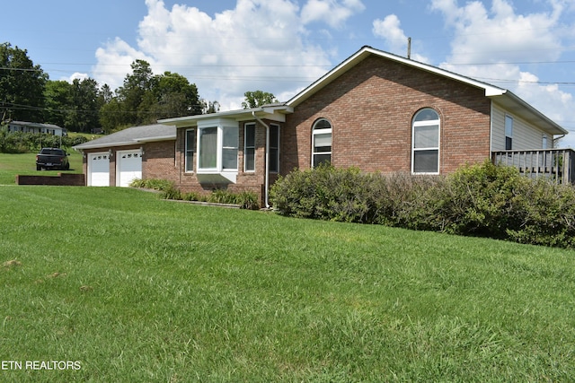 view of front facade with a garage and a front lawn