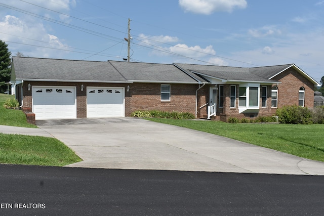 ranch-style home with a garage and a front yard