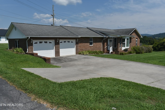 ranch-style home with a garage and a front lawn