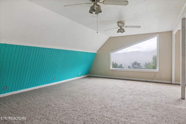 bonus room with vaulted ceiling, carpet flooring, and ceiling fan