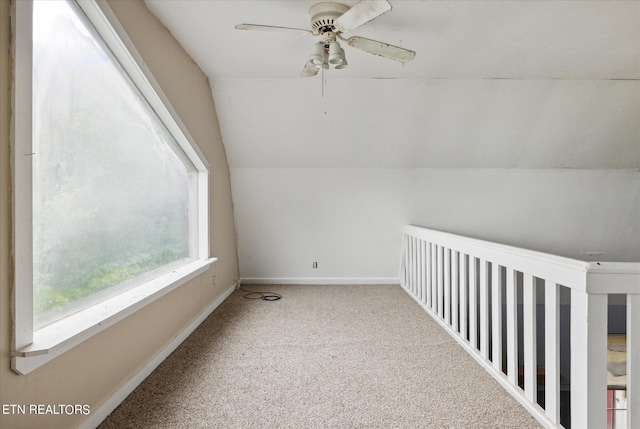 additional living space with ceiling fan, lofted ceiling, and carpet floors