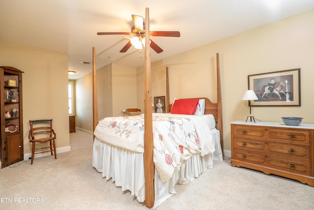 bedroom with baseboards, a ceiling fan, and light colored carpet