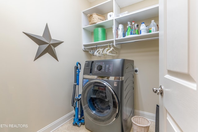 washroom with washer / clothes dryer, baseboards, and laundry area