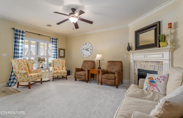 living area with visible vents, a ceiling fan, ornamental molding, carpet, and a brick fireplace