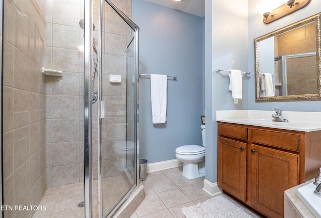 full bath with tile patterned flooring, toilet, vanity, baseboards, and a stall shower