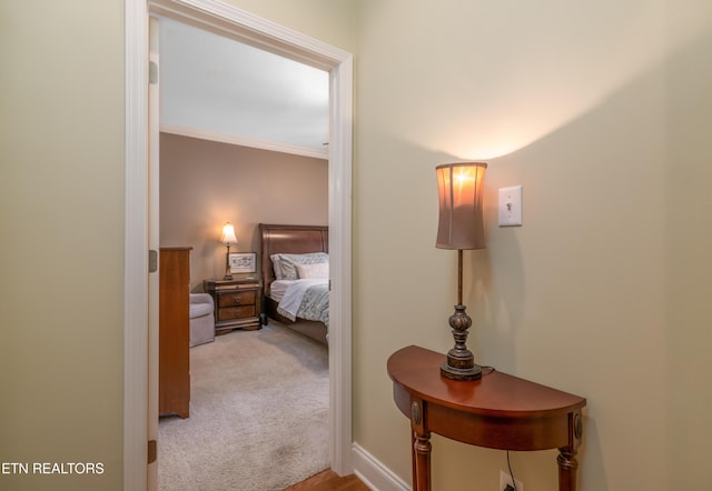 bedroom featuring baseboards, ornamental molding, and carpet flooring