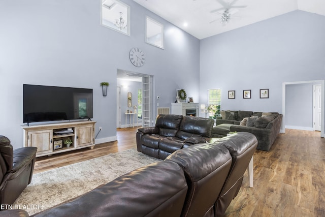 living room featuring high vaulted ceiling, ceiling fan, and hardwood / wood-style floors