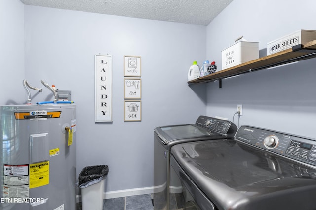 clothes washing area featuring electric water heater, tile patterned flooring, washer and dryer, and a textured ceiling