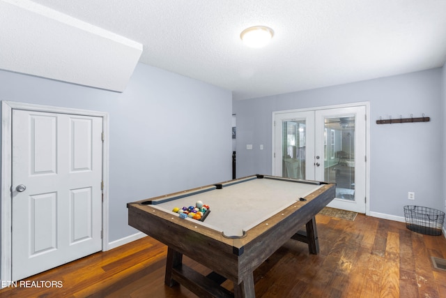 playroom with a textured ceiling, dark hardwood / wood-style floors, french doors, and billiards