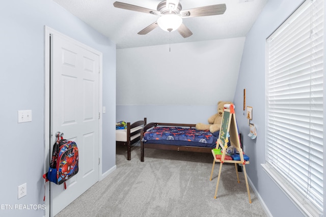 carpeted bedroom with ceiling fan and lofted ceiling