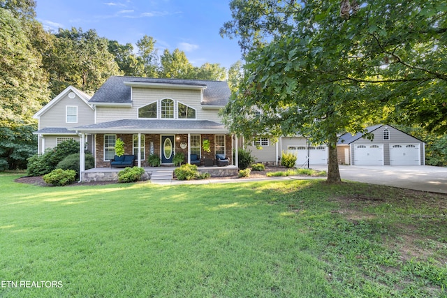 view of front of home featuring a garage, an outbuilding, a porch, and a front lawn