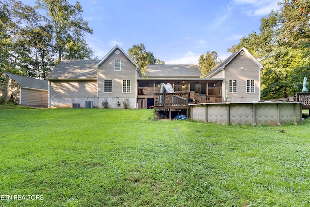 back of house featuring a yard, a deck, and central AC unit