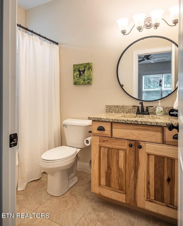 bathroom featuring vanity, tile patterned flooring, ceiling fan, and toilet