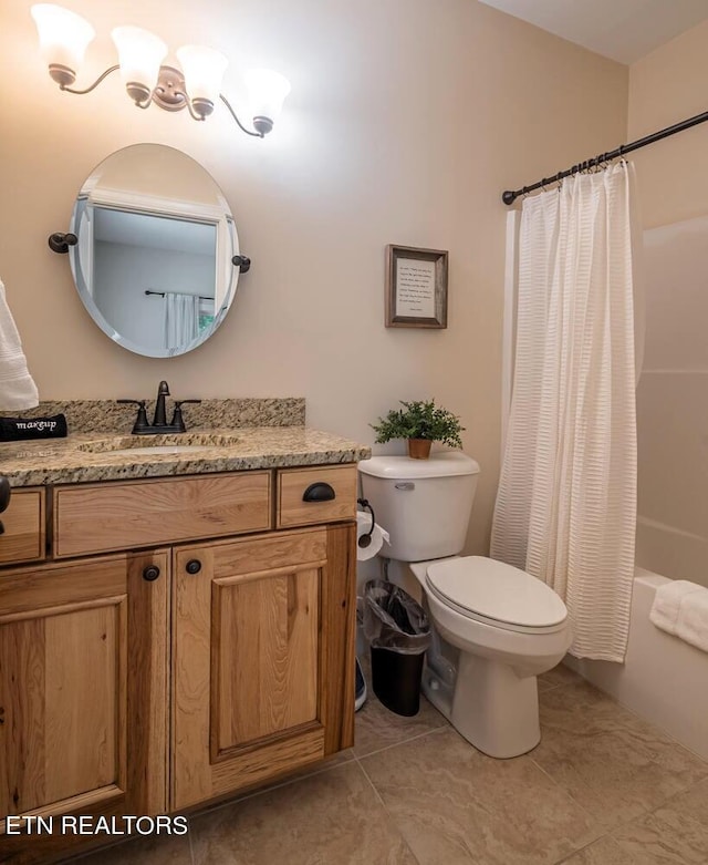 bathroom featuring vanity, tile patterned floors, and toilet