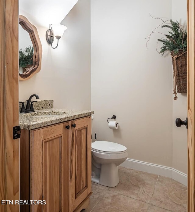 bathroom featuring tile patterned floors, toilet, and vanity