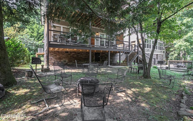 rear view of house with a deck and a patio area