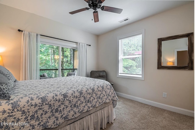 carpeted bedroom with multiple windows, access to exterior, and ceiling fan