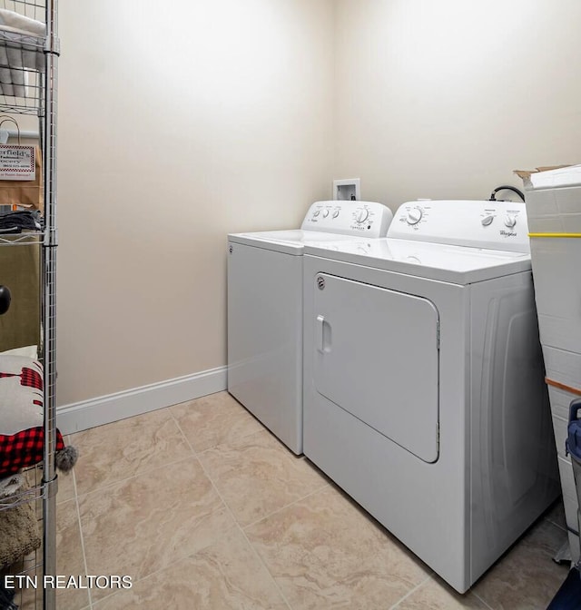 washroom with washing machine and clothes dryer and light tile patterned floors