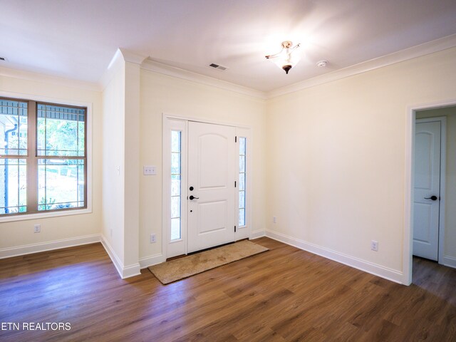 foyer entrance with dark hardwood / wood-style floors and crown molding