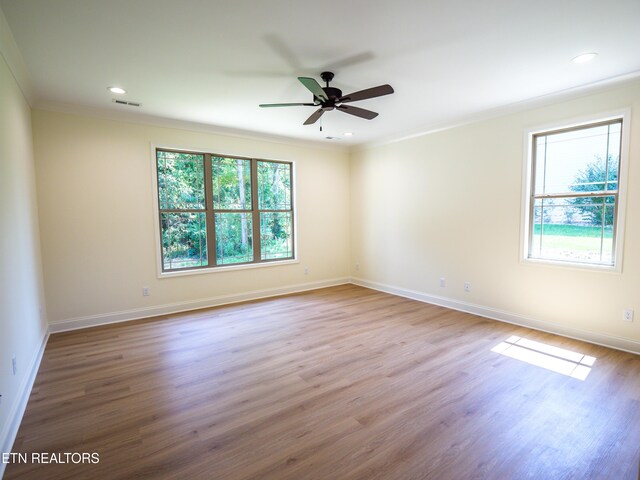 empty room featuring ceiling fan, crown molding, and hardwood / wood-style floors