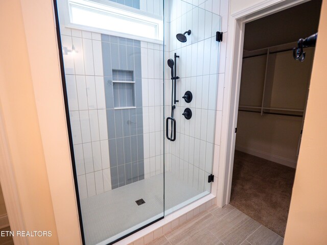 bathroom with tile patterned floors and an enclosed shower