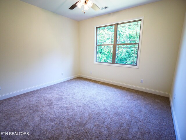 carpeted spare room with ceiling fan