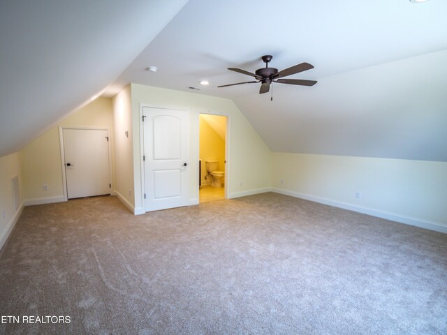 additional living space with ceiling fan, light carpet, and vaulted ceiling