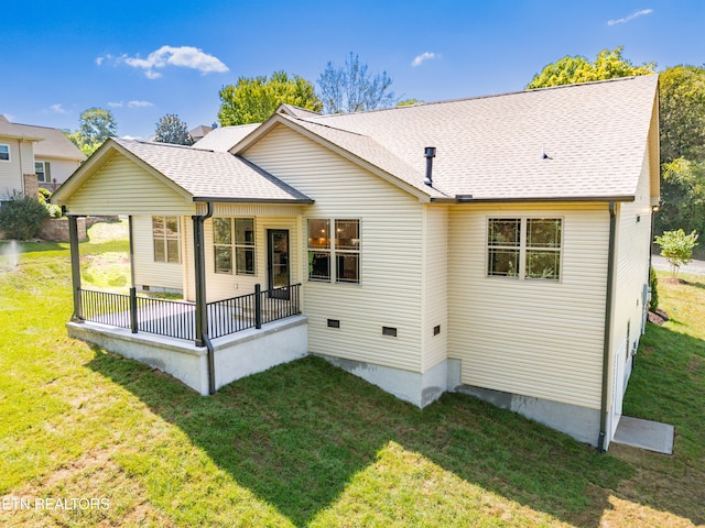 back of house featuring a yard