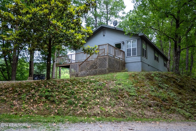 view of side of property featuring a deck