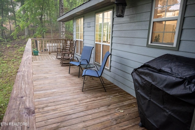 wooden deck featuring area for grilling